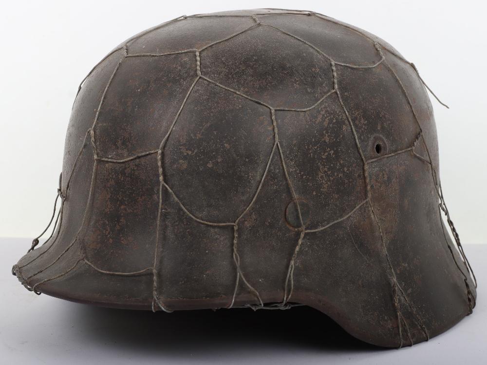 WW2 German Army M-40 Steel Combat Helmet with Chicken: WW2 German Army M-40 Steel Combat Helmet with Chicken Wire Basket, sleepy untouched example of a standard M-40 pattern combat helmet which retains much of its original dark combat paint finish to both
