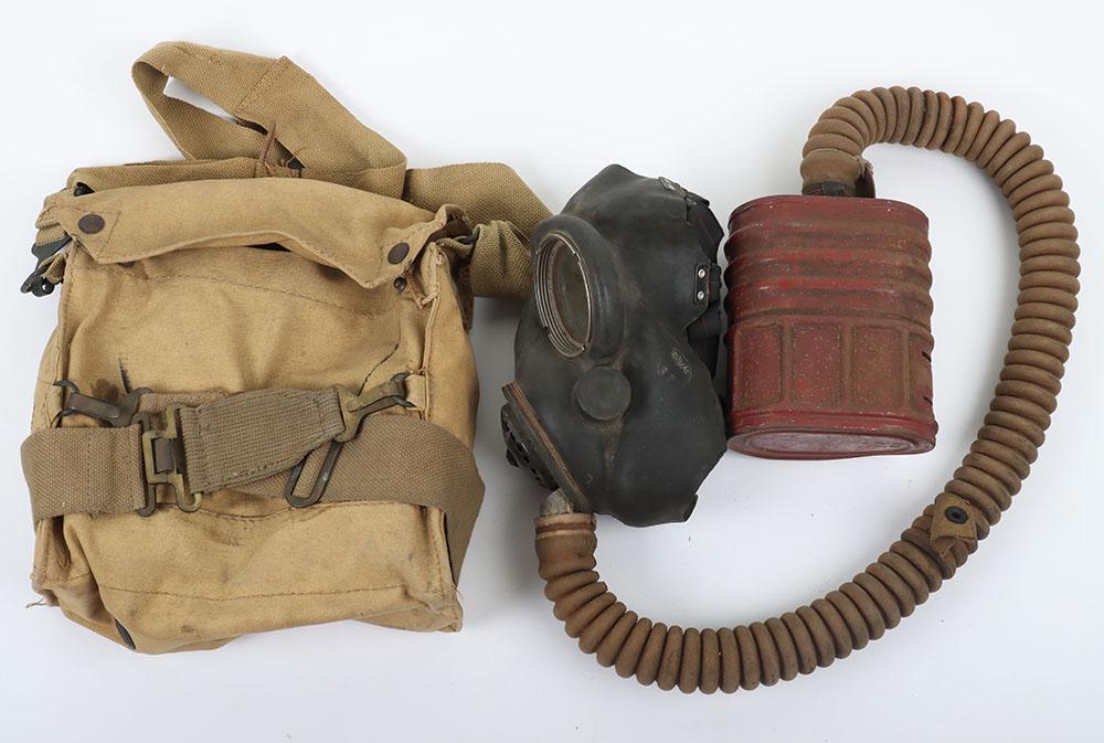 WW2 British Gas Mask Variation: WW2 British Gas Mask Variation, having black rubber face piece is dated 6/39, the head harness is dated 5/39, the red cannister is dated 14/6/40. This respirator has the extra-long hose for issue to A