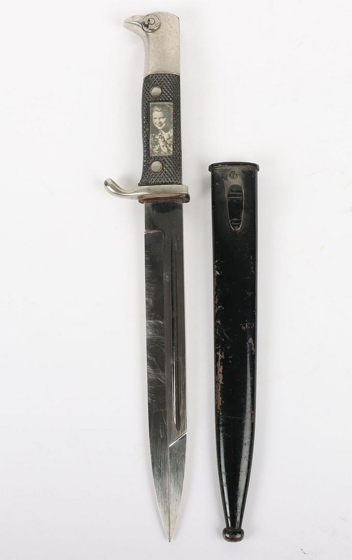 Personalised WW2 German Parade Bayonet by Ernst Pack & Sohne Solingen: Personalised WW2 German Parade Bayonet by Ernst Pack & Sohne Solingen, the standard parade bayonet with two piece chequered grips, the centre of which has been cut out a photographs of a German soldie