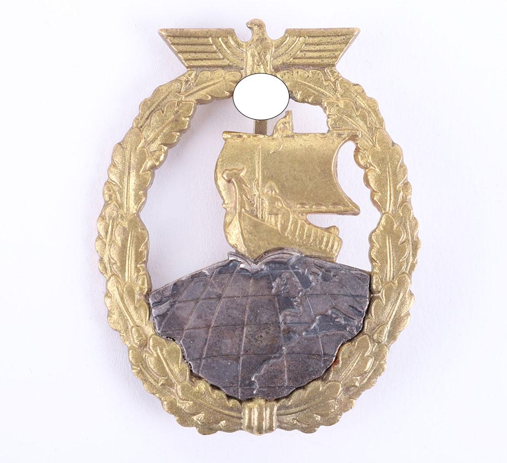 Kriegsmarine Auxiliary Cruiser War Badge: Kriegsmarine Auxiliary Cruiser War Badge, being a good quality reproduction example of a Kriegsmarine Auxiliary cruiser war badge with Schwerin Berlin makers mark to the reverse. Pin and catch fixing 