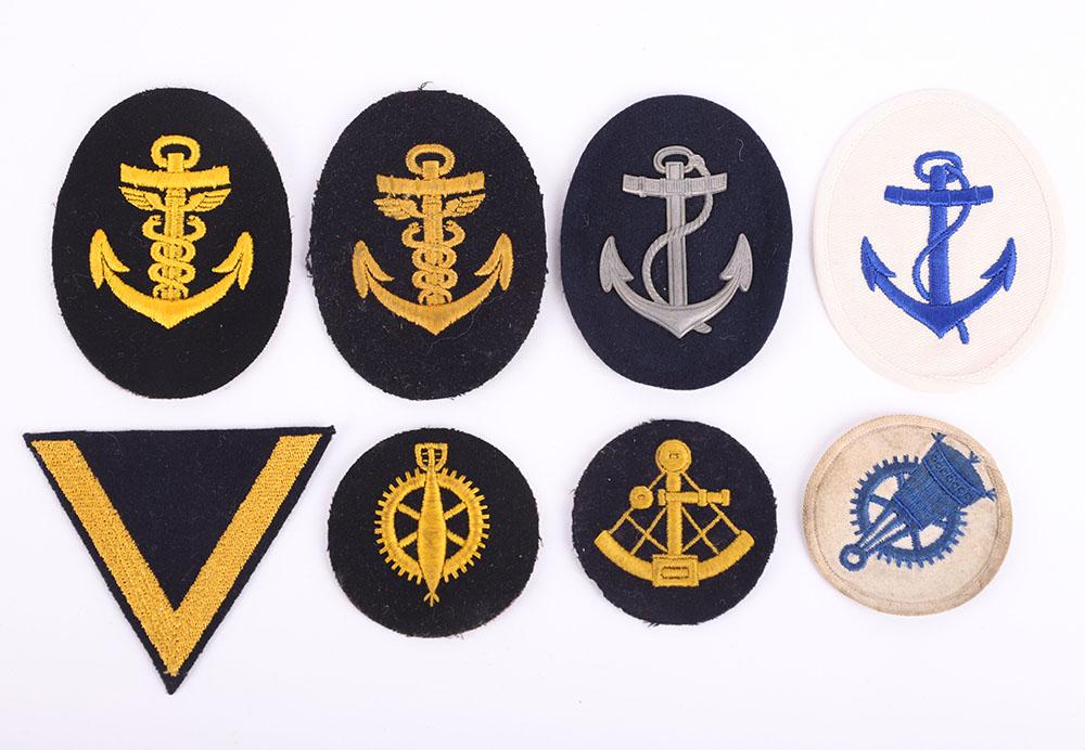 WW2 German Kriegsmarine Cloth Insignia: WW2 German Kriegsmarine Cloth Insignia, including both summer and winter pattern cloth trade / proficiency badges and one rank chevron. One metal rank / trade badge. (8 items)