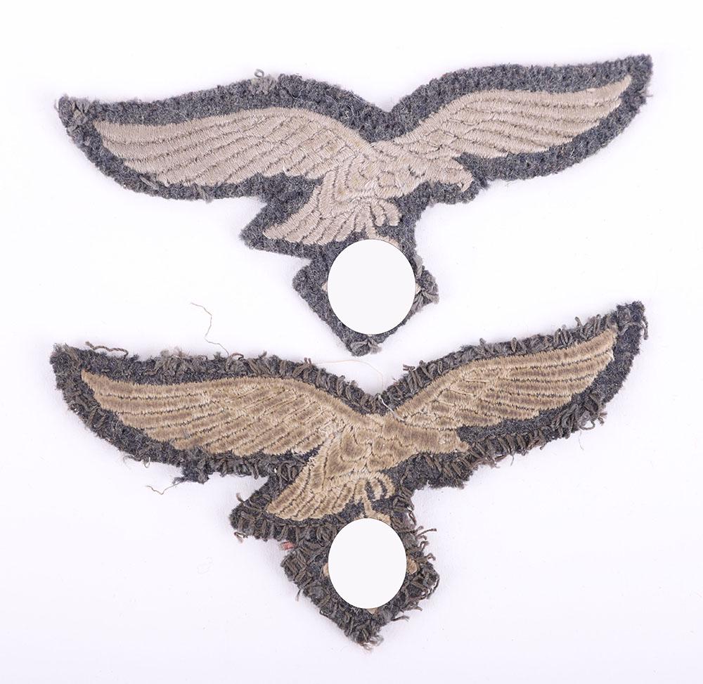 2x WW2 German Luftwaffe Tunic Breast Eagles: 2x WW2 German Luftwaffe Tunic Breast Eagles, both being embroidered other ranks examples. Both show evidence of uniform removal.