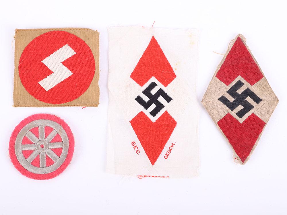 Third Reich Hitler Youth Insignia: Third Reich Hitler Youth Insignia, consisting of a mint un-issued cloth diamond arm badge, uniform removed example, HJ motor drivers proficiency badge and an un-issued DJ sigrune insignia. Generally a