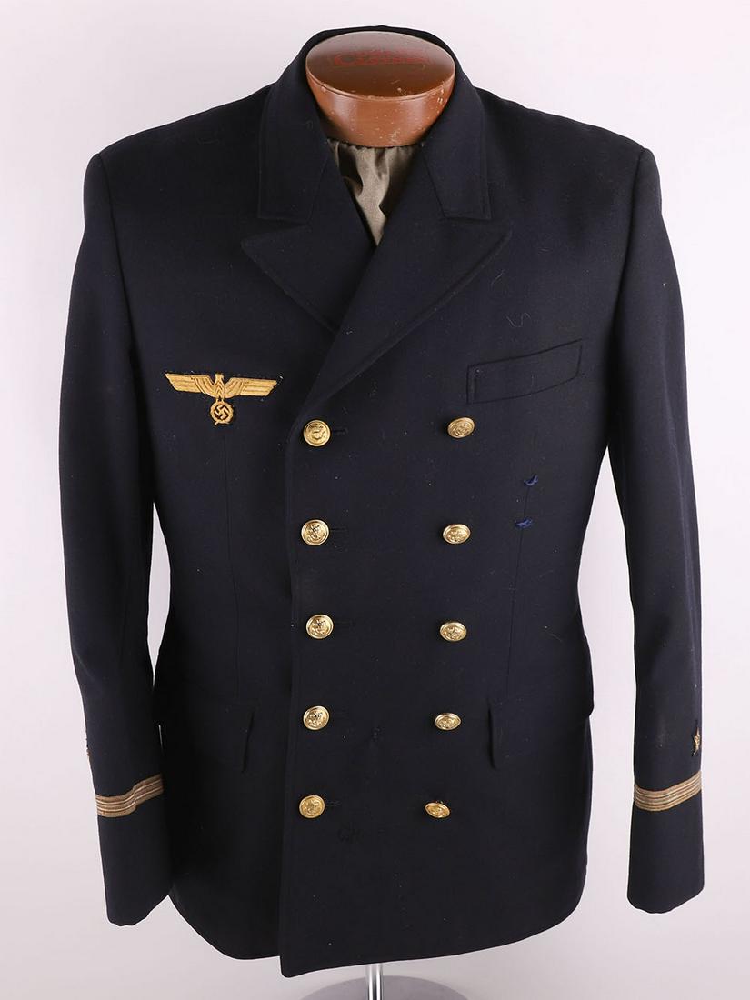 German Kriegsmarine Officers Tunic: German Kriegsmarine Officers Tunic, double breasted blue tunic with original celluloid Kriegsmarine tunic breast eagle attached. Miss-matched Kriegsmarine tunic buttons. Rank lace and star to the cuff