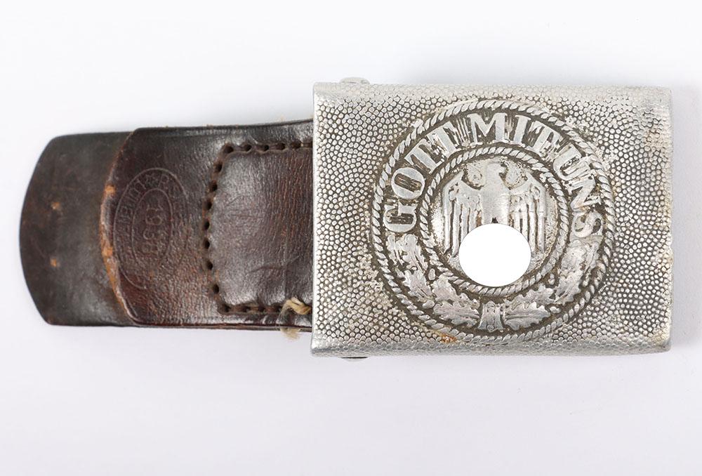 WW2 German Army Belt Buckle: WW2 German Army Belt Buckle, good combat pattern belt buckle constructed from aluminium. Complete with its brown leather tab which is stamped with makers details of ‘R Sieper & Sohn Ludenscheid’. 