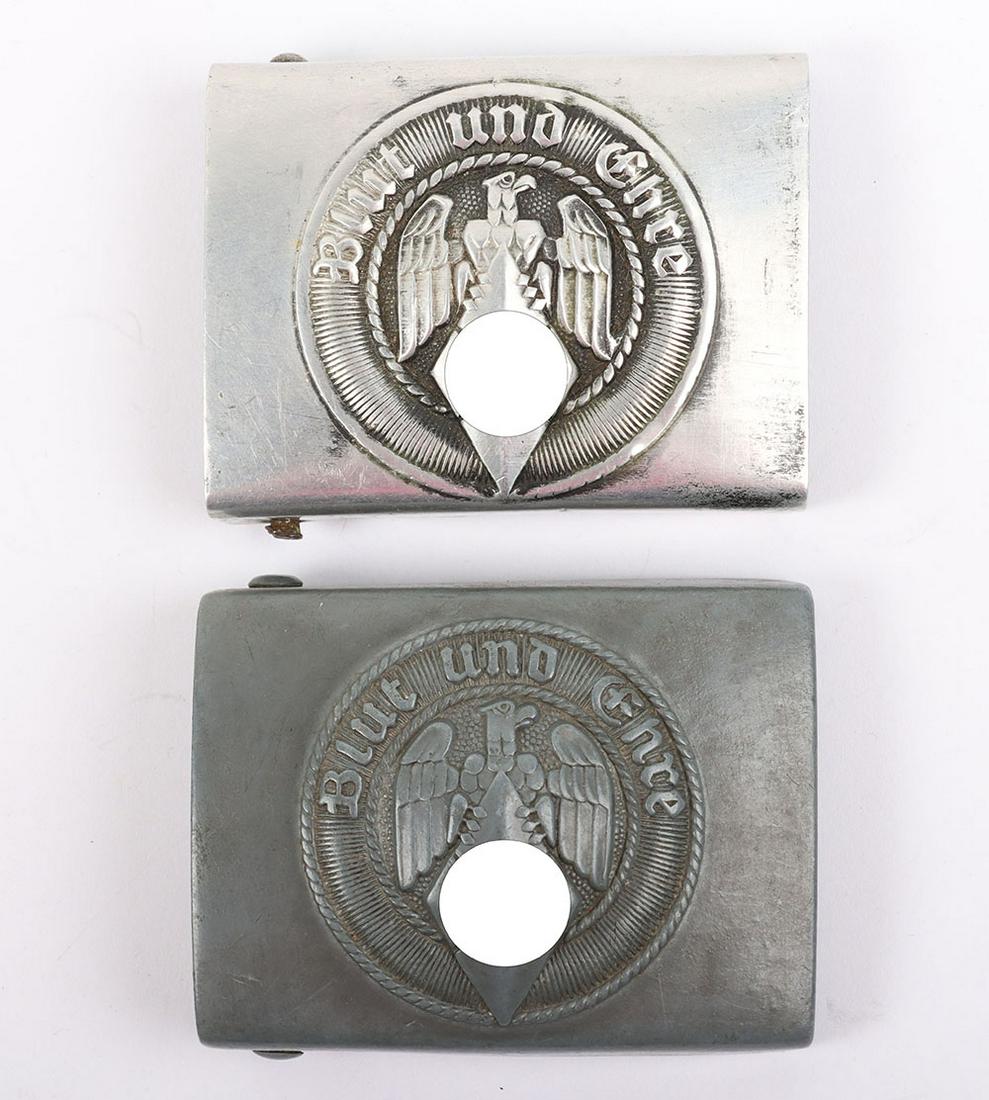 2x Third Reich Hitler Youth Belt Buckles: 2x Third Reich Hitler Youth Belt Buckles, including an aluminium example with the fittings to the reverse and a solid zinc example which is marked with RZM M4/46. Both show some wear. (2 items)