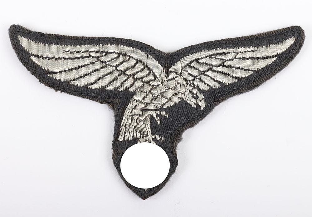 WW2 German Luftwaffe 1st Pattern Tunic Breast Eagle: WW2 German Luftwaffe 1st Pattern Tunic Breast Eagle, good example of a silver flat wire embroidered 1st pattern droop tail breast eagle with the reverse having the blue / grey cloth tunic backing.