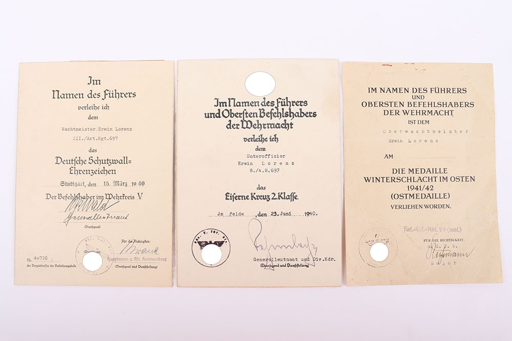 WW2 German Award Citation Group of Three Artillery Regiment 697: WW2 German Award Citation Group of Three Artillery Regiment 697, all three awarded to Erwin Lorenz, consisting of Eastern Front medal citation when rank of Oberwachtmeister, West Wall medal when rank 