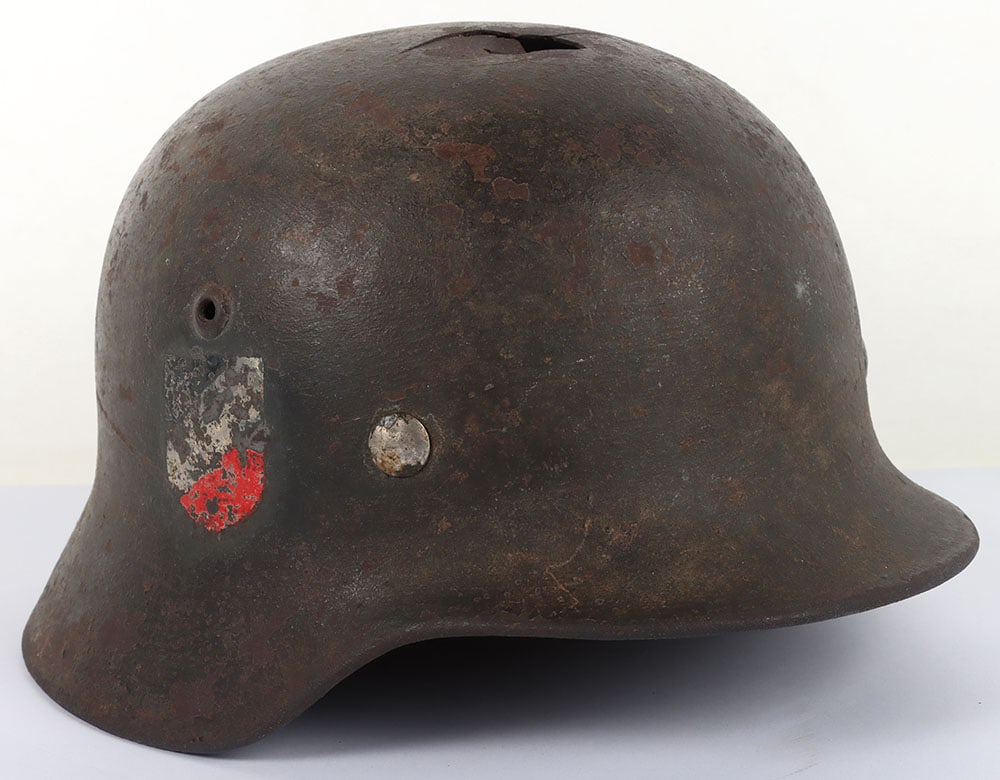 WW2 German Army M-35 Double Decal Battle Damaged Steel Combat Helmet Attributed to Leutnant Becker: WW2 German Army M-35 Double Decal Battle Damaged Steel Combat Helmet Attributed to Leutnant Becker, fine example of an M-35 steel combat helmet with a rough textured overpaint finish to the exterior o
