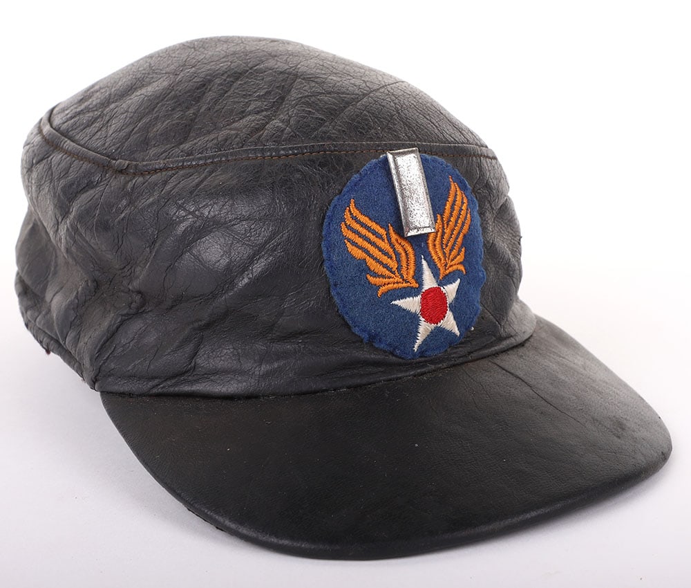 AMERICAN WWII USAAF CAP: AMERICAN WWII USAAF CAP, commercial example, made of black leather w/ black leather visor, has a black cloth quilted lining w/ leather headband, sewn on front is USAAF wool patch along with an attache