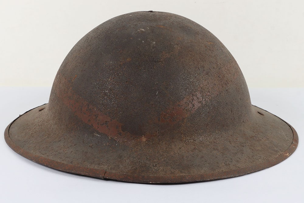 WW1 British Steel Combat Helmet Shell of the Northumberland Fusiliers: WW1 British Steel Combat Helmet Shell of the Northumberland Fusiliers, untouched example of a 2nd pattern Brodie shell with covering to the brim. Helmet has red painted ?V? insignia around the shell, 