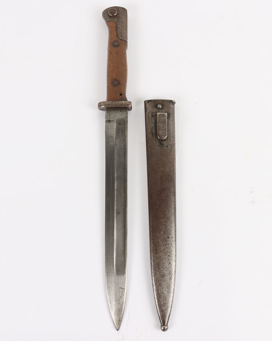 Imperial German S84/98 Bayonet: Imperial German S84/98 Bayonet, with two piece wooden grips, steel pommel and short cross guard. Housed in a steel scabbard. Rear of the cross guard stamped with regimental markings, ?12. R. 4. 240?. 