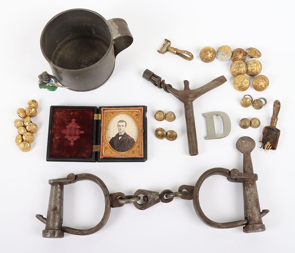 US CIVIL WAR UNION LOT OF 8 ITEMS PLUS: US CIVIL WAR UNION LOT OF 8 ITEMS PLUS, a tin drinking cup 2 ?? tall, a period pr. of iron hand cuffs w/ key, a musket tool, 2 brass sword hanger snaps, a ?D? 1 ?? tall unit number, 2 Eagle cuff butto