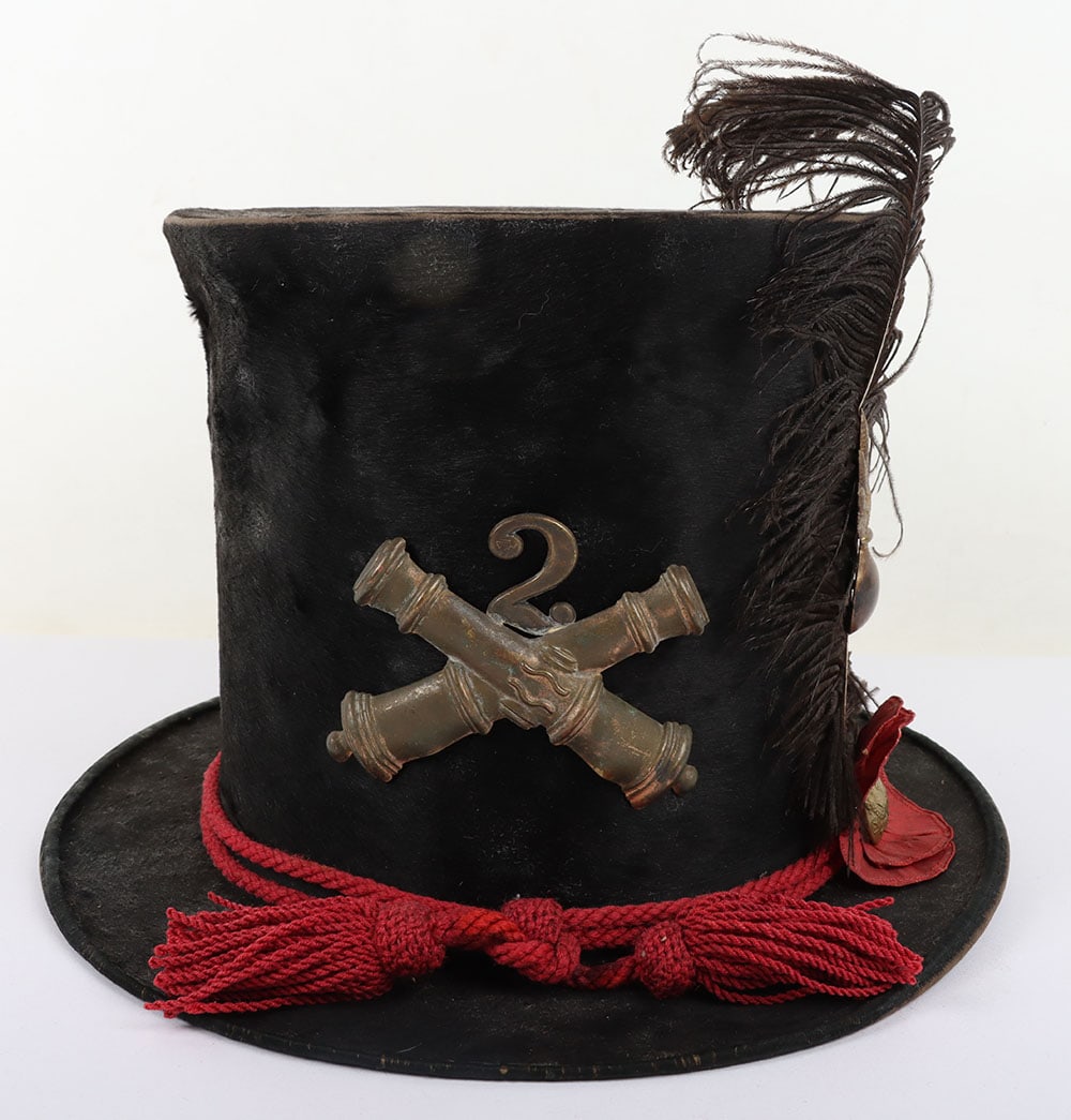 US CIVIL WAR PERIOD UNION MILITA ARTILLEY TOP HAT: US CIVIL WAR PERIOD UNION MILITA ARTILLEY TOP HAT, unusual, is made of a black beaver skin & stands 6? tall with a 1 ?? brim, on front is a 3? wide brass crossed cannons w/ its Regimental # ?2? attach