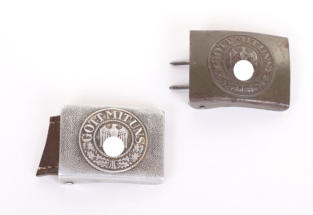2 WW2 GERMAN HEER EM BUCKLES: 2 WW2 GERMAN HEER EM BUCKLES, an aluminum 1-piece mkd. ?L.L.? w/ leather tab cut off, a 1-piece steel one mkd. ?N & H 1941? and retains 80% of its OD paint, both are VG+ - VG++