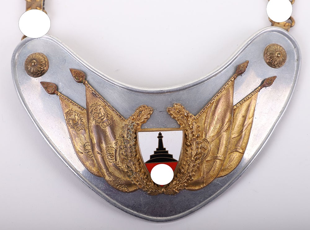 THIRD REICH VETERANS FLAG BEARERS GORGET: THIRD REICH VETERANS FLAG BEARERS GORGET, 9 ?? wide x 4? tall, appears to be aluminum, attached to the front is an array of Imperial & Third Reich flags (gold-gilted brass) w/ a center monument & swas