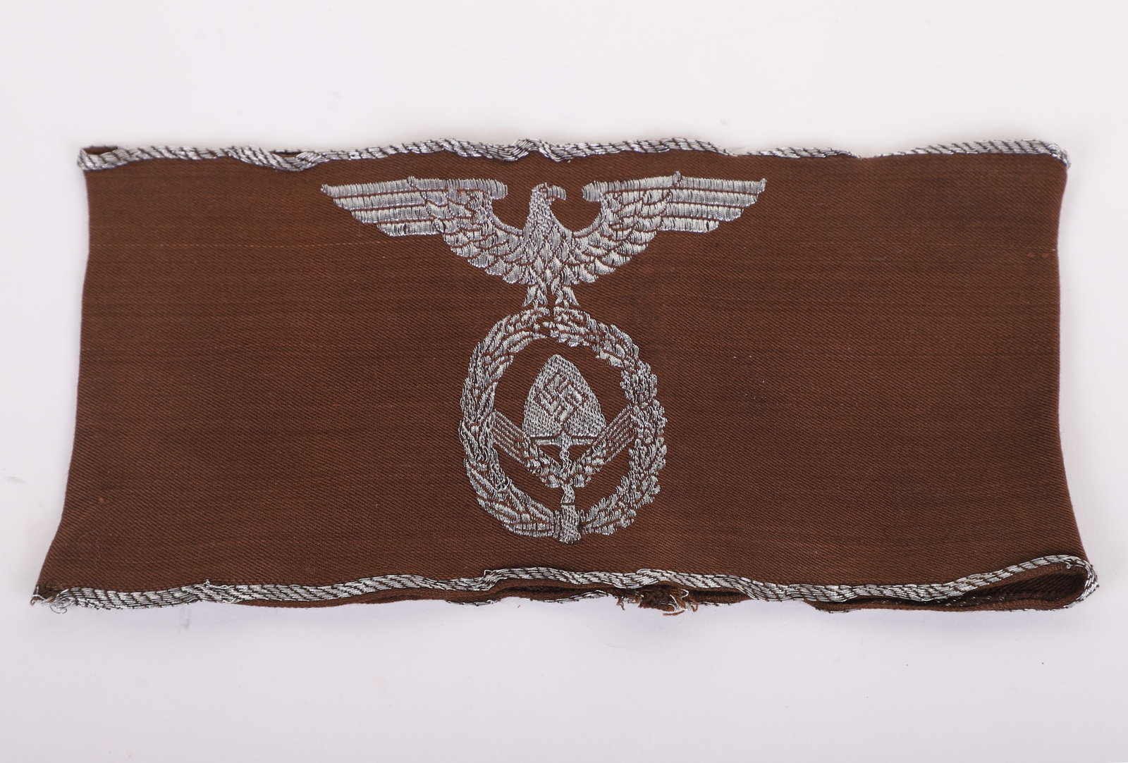SCARCE THIRD REICH RAD (LABOUR SERVICE) OFFICERS ARMBAND: SCARCE THIRD REICH RAD (LABOUR SERVICE) OFFICERS ARMBAND, brown cloth with silver wire eagle to the center having RAD emblem to the center. Good overall condition.