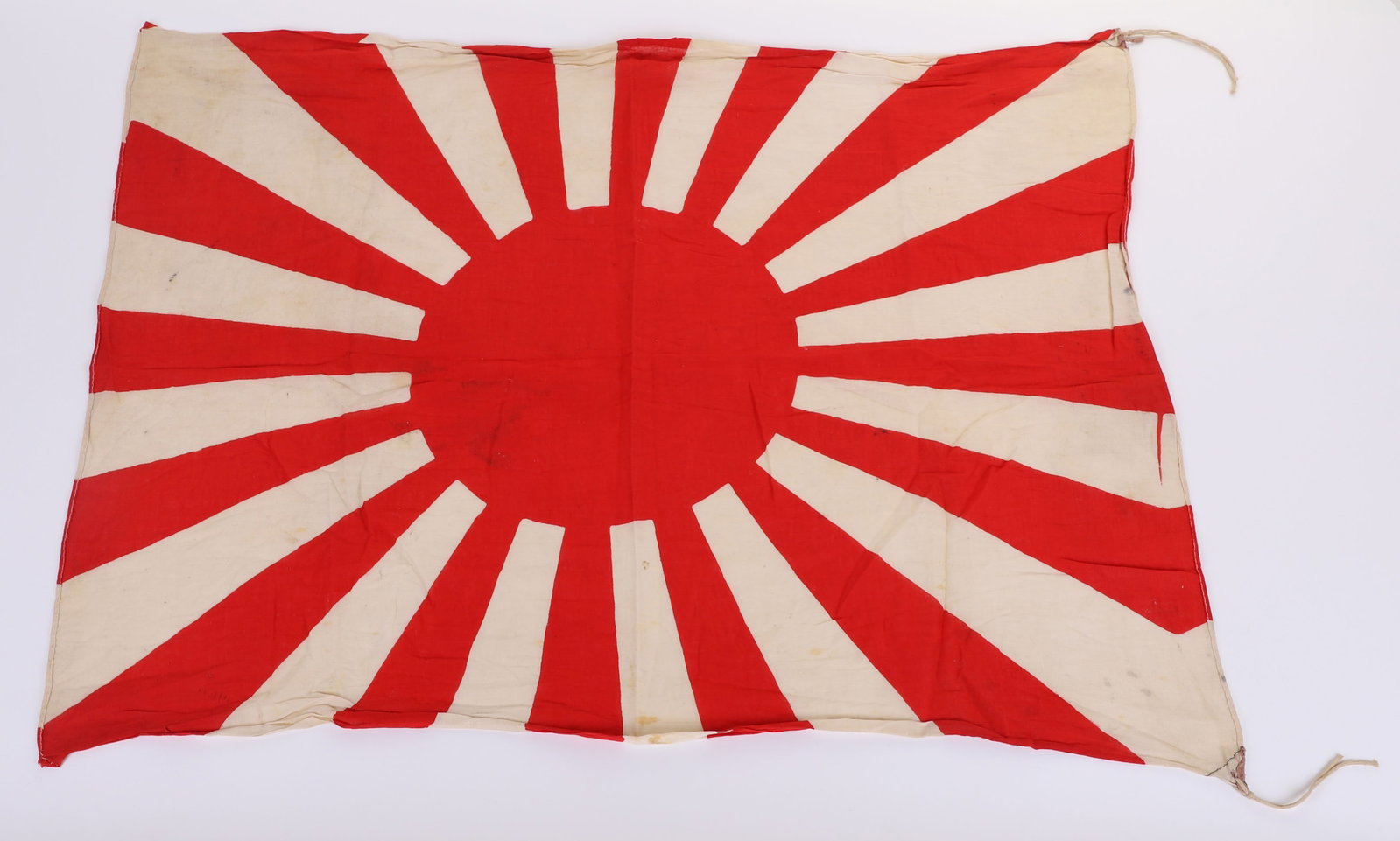 WW2 JAPANESE RISING SUN (NAVAL) BATTLE FLAG: WW2 JAPANESE RISING SUN (NAVAL) BATTLE FLAG, good example of a small printed cotton battle flag in the form of the Rising Sun as associated with the Imperial Japanese navy and marines. The flag has cl