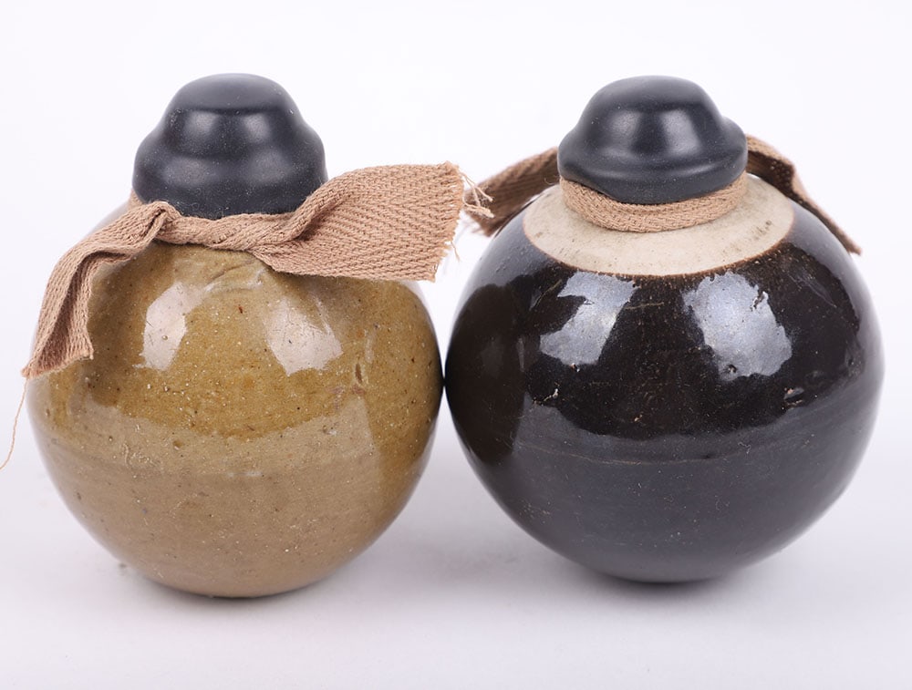 2x INERT WW2 JAPANESE CERAMIC HAND GRENADES: 2x INERT WW2 JAPANESE CERAMIC HAND GRENADES, both being glazed ceramic grenades with the rubber caps and cloth ties. Both empty and safe. Type used on the island of Okinawa. PLEASE NOTE ONLY SUITABLE