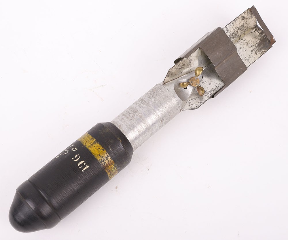 INERT WW2 JAPANESE HEAT CLUSTER BOMB: INERT WW2 JAPANESE HEAT CLUSTER BOMB, fine example with much of the original finish remaining to the body. Complete with the metal fins and small brass propeller. Nicely market. Empty and safe. PLEASE