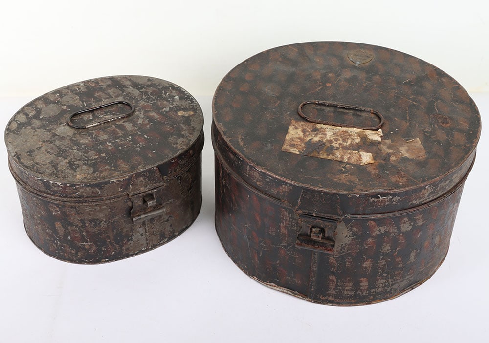British Military Headdress Storage Tins: British Military Headdress Storage Tins: Two Japanned finish storage tins for officers peak hat with brass makers name plate HAWKES & CO and pill box hat. 2 items