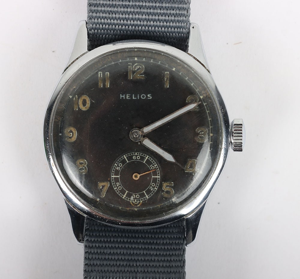 WW2 German Military Issue Wristwatch: WW2 German Military Issue Wristwatch: Black dial Swiss made HELIOS wristwatch with correct stamping to back D 1616 H , in working order on later strap.