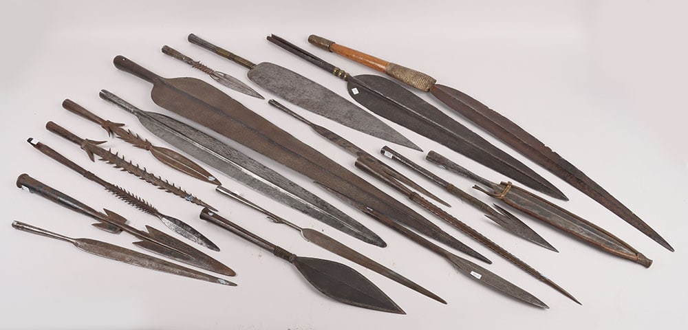 17x Assorted African Tribal Spear Heads: 17x Assorted African Tribal Spear Heads , mostly 19 th century; an African arrow; and African curved shortsword with monitor lizard skin covering to the ferule; and 3 assorted gun cleaning rods. Avera