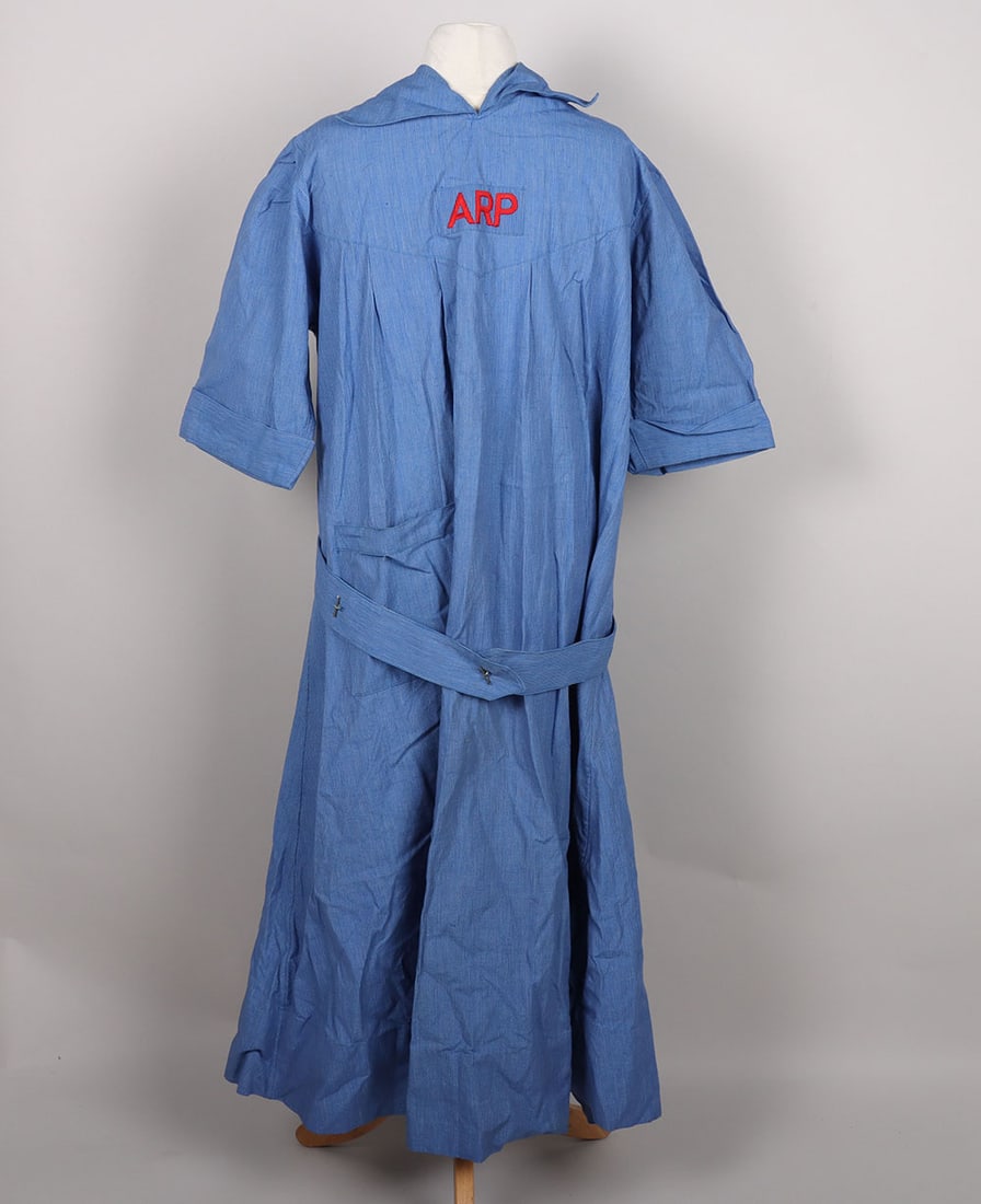 WW2 British Female ARP Dress: WW2 British Female ARP Dress, blue cloth pin stripe dress with embroidered ARP rectangular insignia to the centre. Open back and fixed belt with bakelite buttons. Accompanied by a white cloth nurses h