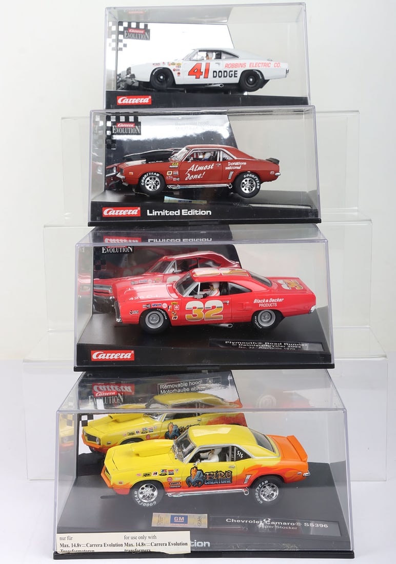 Four boxed Carrera Evolution slot cars,: Four boxed Carrera Evolution slot cars, Dodge Charger 500 No.41 Riverside 1969, ~Plymouth Road Runner No.32 Riverside 1970, Chevrolet Camaro Super Stocker, Primer red, Chevrolet Camaro SS396 Super Sto