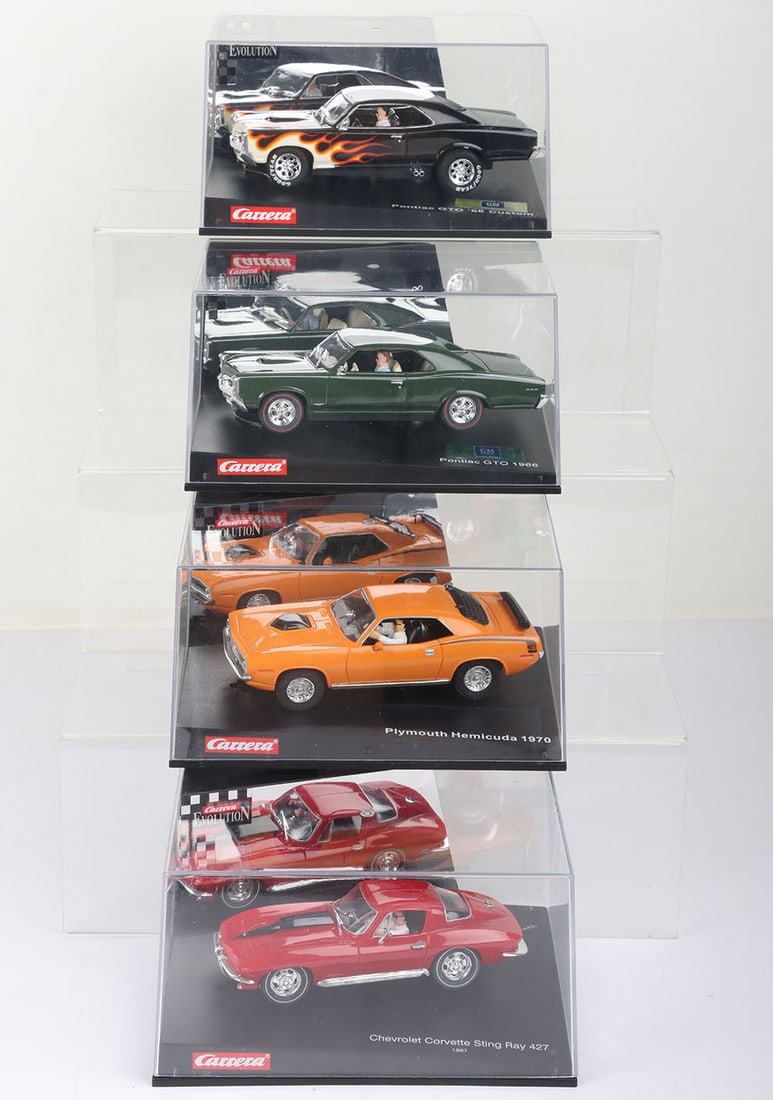 Four boxed Carrera Evolution slot cars, (1 of 2)