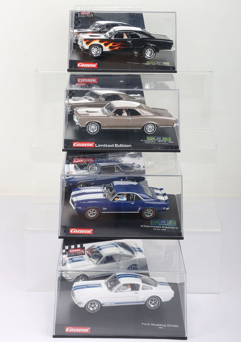Four boxed Carrera Evolution slot cars, (1 of 2)