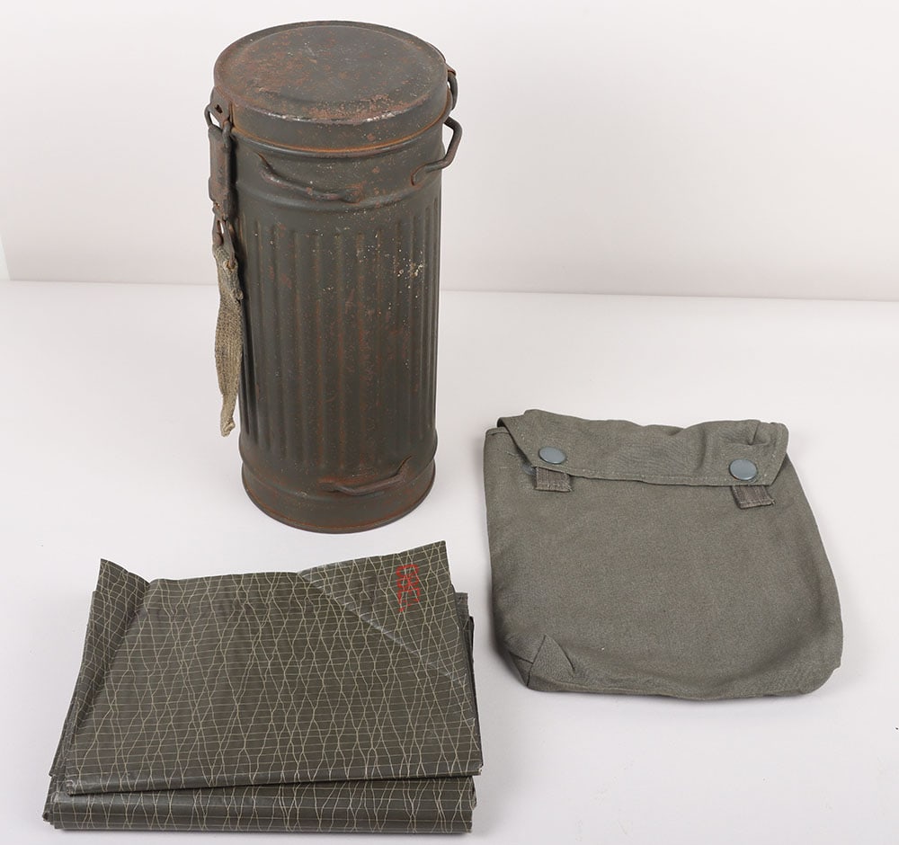 WW2 German Gas Mask with Canister and Gas Cape: WW2 German Gas Mask with Canister and Gas Cape, gas mask complete with filters (no cloth). Inside named to “Obergefreiter Rosenfeld”. No carrying straps. The gas mask comes with a rarer gas ca