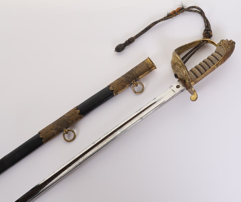 Victorian Royal Naval Officers Sword: Victorian Royal Naval Officers Sword, lion head pommel, blue striped bullion dress knot (missing end section), housed in leather with brass mounts scabbard, decoration for a Flag Rank officer. Polishe