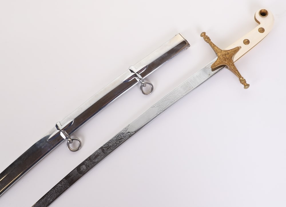 Elizabeth II Period Mameluke Sword by Wilkinsons: Elizabeth II Period Mameluke Sword by Wilkinsons, 87130, two piece grips with gilt metal mounts. Brass cross guard with crossed sword and baton to the centre. Housed in polished steel scabbard with tw