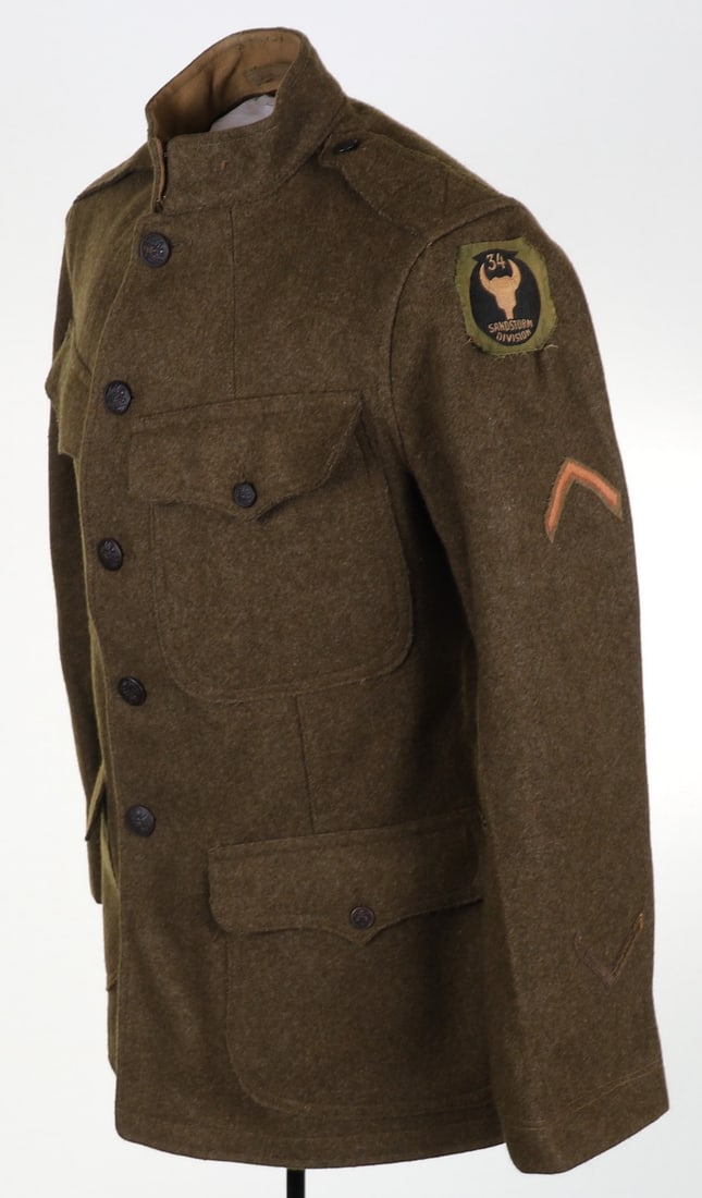 WW1 American Tunic with 34th Sandstorm Division Liberty Loan Patch: WW1 American Tunic with 34th Sandstorm Division Liberty Loan Patch, four pocket heavy khaki wool tunic with American eagle buttons, no collar discs, Quartermaster Corps rank patch to arm with the othe