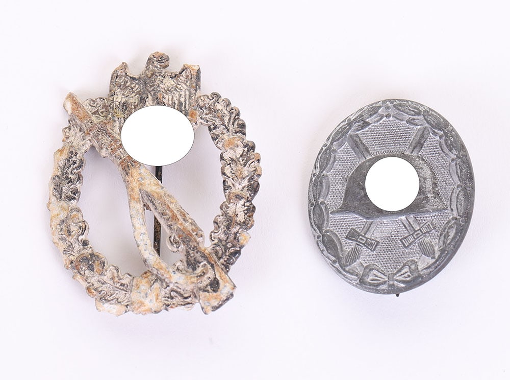 WW2 German Armed Forces Silver Wound Badge by Hauptmunzamt, Wien: WW2 German Armed Forces Silver Wound Badge by Hauptmunzamt, Wien, complete with the original pin and catch fixing to the reverse. Accompanied by a relic battle field dug up infantry assault badge. (2 