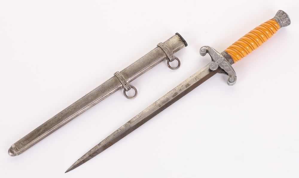 WW2 German Army Officers Dress Dagger by E & F Horster, Solingen: WW2 German Army Officers Dress Dagger by E & F Horster, Solingen, with orange celluloid grip, complete with pommel, ferrule and cross guard. Housed in its original scabbard. Double edged blade with ma