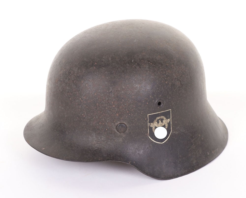 WW2 German Field Police Double Decal M-42 Steel Combat Helmet: WW2 German Field Police Double Decal M-42 Steel Combat Helmet, fine example of a M-42 raw edge steel combat helmet which retains much of its original combat paint finish to the shell. Helmet has both 