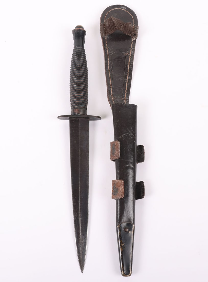 1971 British Fairbairn Sykes (F.S) Commando Knife: 1971 British Fairbairn Sykes (F.S) Commando Knife , blackened ribbed grip, oval cross guard stamped with Sheffield makers stamp and broad arrow with 1971 date and 1B-4432. Housed in its leather scabba