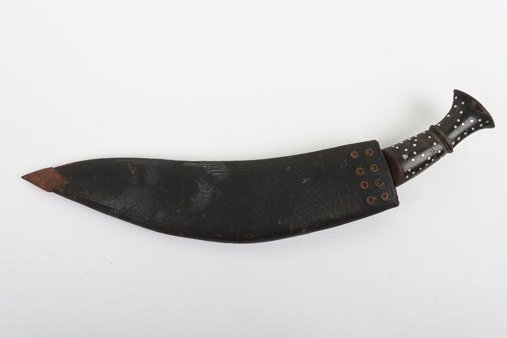Gurkha Kukri in Leather Scabbard: Gurkha Kukri in Leather Scabbard, Old period kukri with decorative handle and sheathed in a patterned leather scabbard. The blade has suffered from rusting but could be cleaned up easily enough. One o
