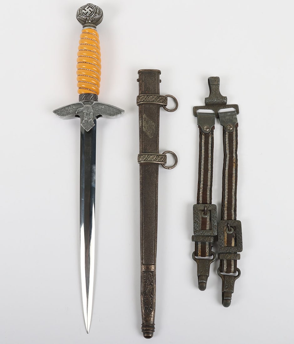 WW2 German Luftwaffe 2nd Pattern Dress Dagger with Straps by Ernst Pack & Sohne: WW2 German Luftwaffe 2 nd Pattern Dress Dagger with Straps by Ernst Pack & Sohne, orange celluloid grip with wire binding. Pommel with swastika to both sides, cross guard in form of eagle in flight wi