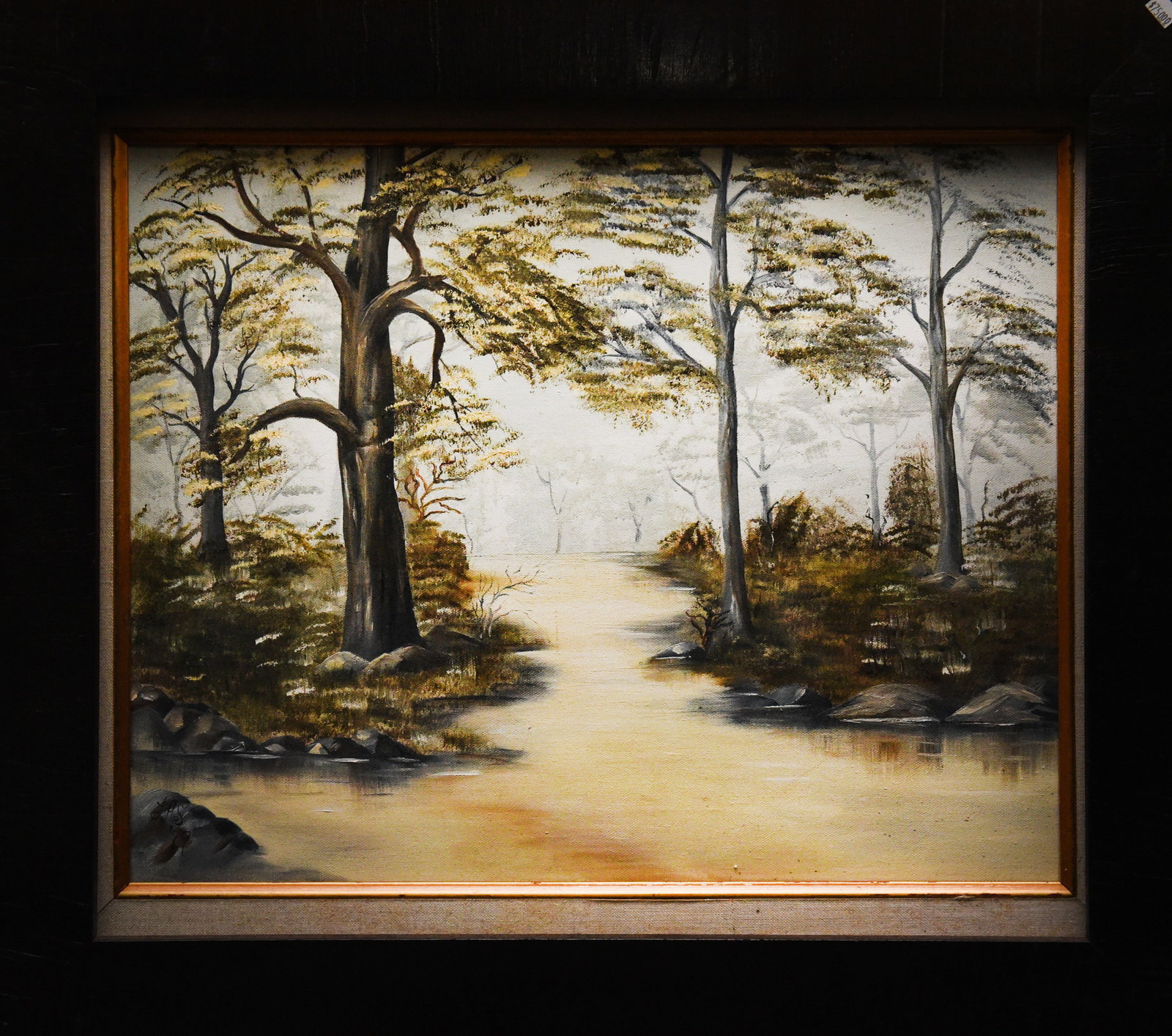 Forest River Landscape: Oil on canvas depicting a serene river flowing through a forest landscape. The scene is bathed in a warm, golden light, creating a tranquil atmosphere. Dimensions: 25" x 22" framed.