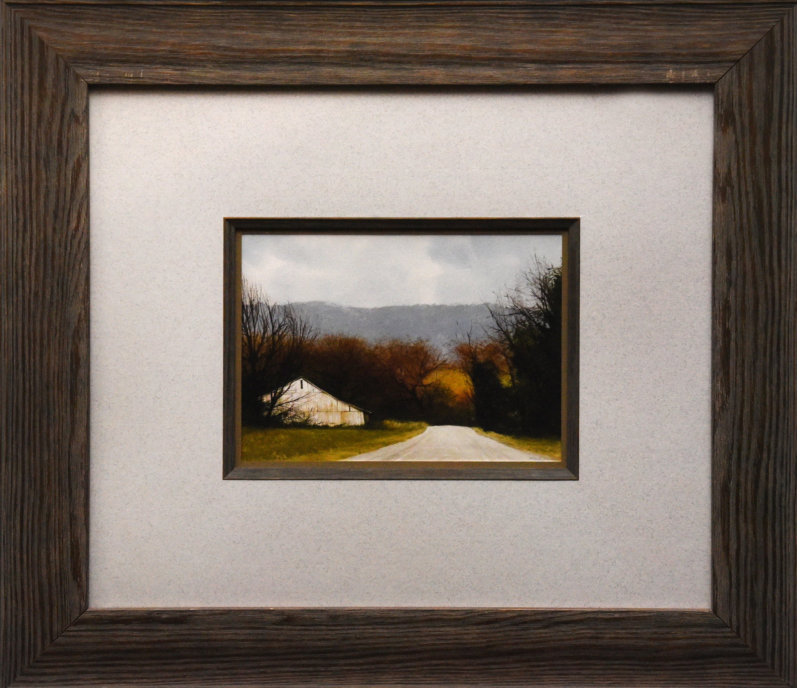 Country Road with Barn: Art print featuring a country road leading towards a distant barn in a rural landscape. The scene evokes a sense of quiet solitude and the charm of the countryside. Dimensions: 23" x 21" framed.