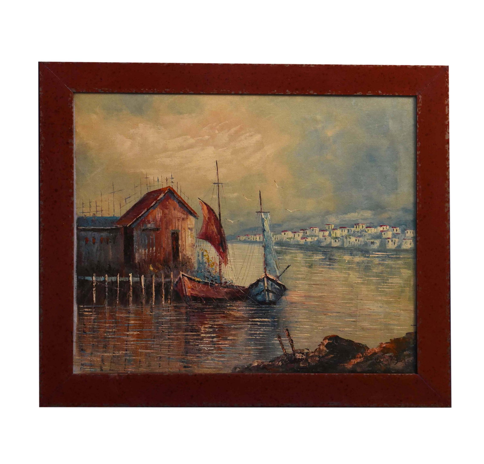 Harbor Serenity Oil On Canvas: An enchanting oil on canvas painting, measuring 28" x 25", captures a serene harbor scene. A rustic red boathouse stands prominently by the water, flanked by two sailboats gently bobbing in the calm r