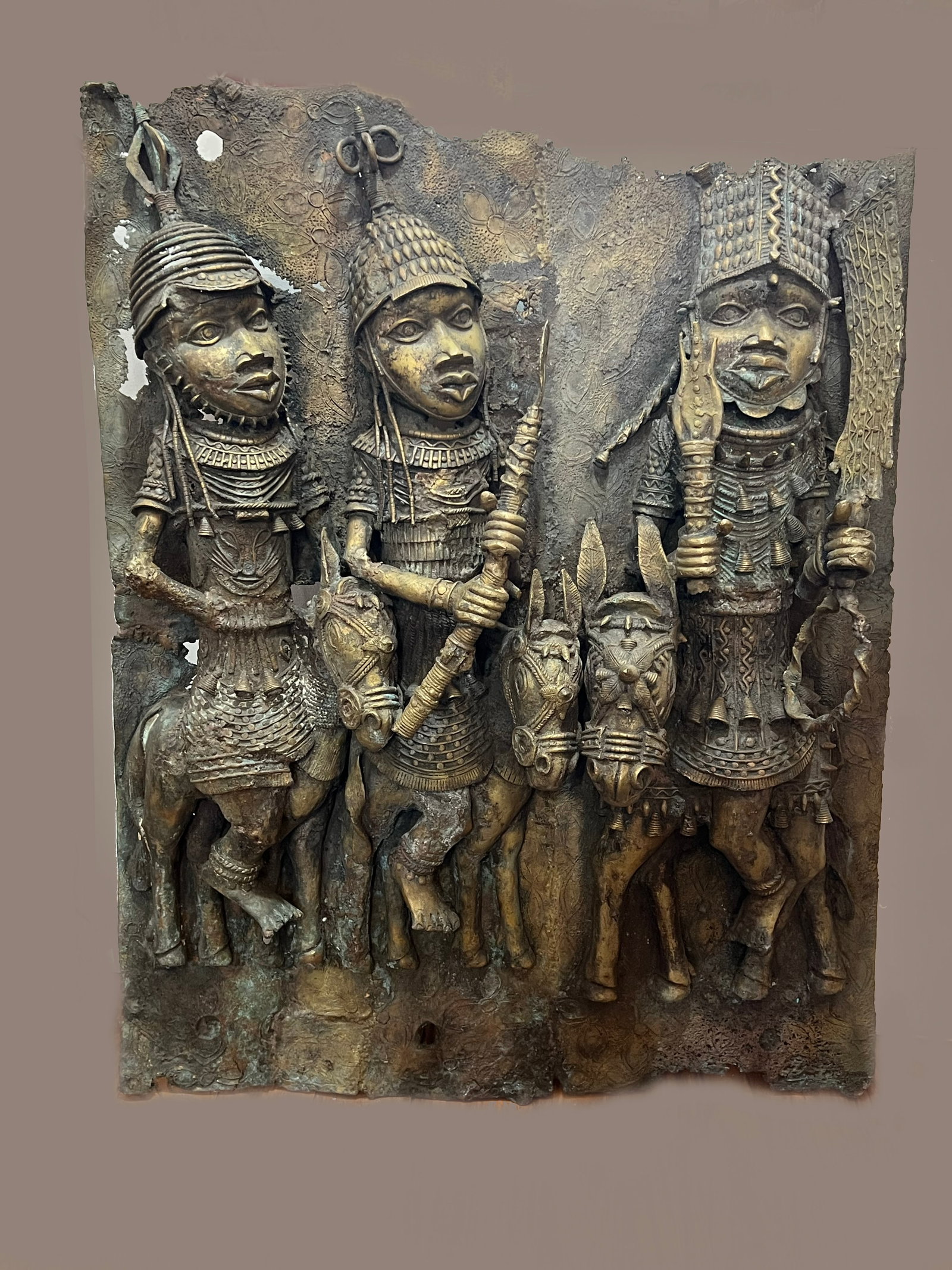 Antique Monumental Benin Bronze Relief Plaque | Royal Oba and Warriors on Horseback | 40" x 30": This massive and heavy bronze relief plaque is a high-relief sculptural masterpiece depicting a royal procession from the historic Benin Kingdom (modern-day Nigeria). Standing at a monumental 40 inche