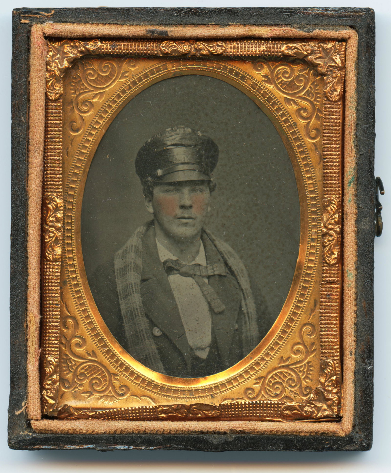 Ambrotype of Man in Rain Covered Wheel Lock Hat: 1/9th Plate Ambrotype of Man in a wheel lock hat with a oil cloth rain covering with a scarf over his shoulders. Only half the case is present.