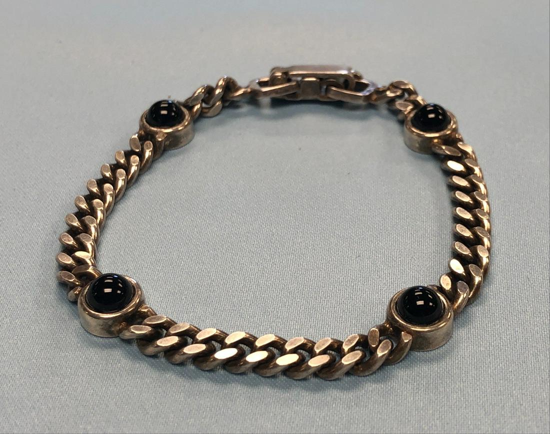 Sterling Silver and Black Onyx Bracelet: Sterling Silver and Black Onyx Bracelet Dimensions: Length: 7" Round Onyx Accents: 4 Makers Mark Not Present Stamped 925 Tested .925 Sterling Silver with a spect