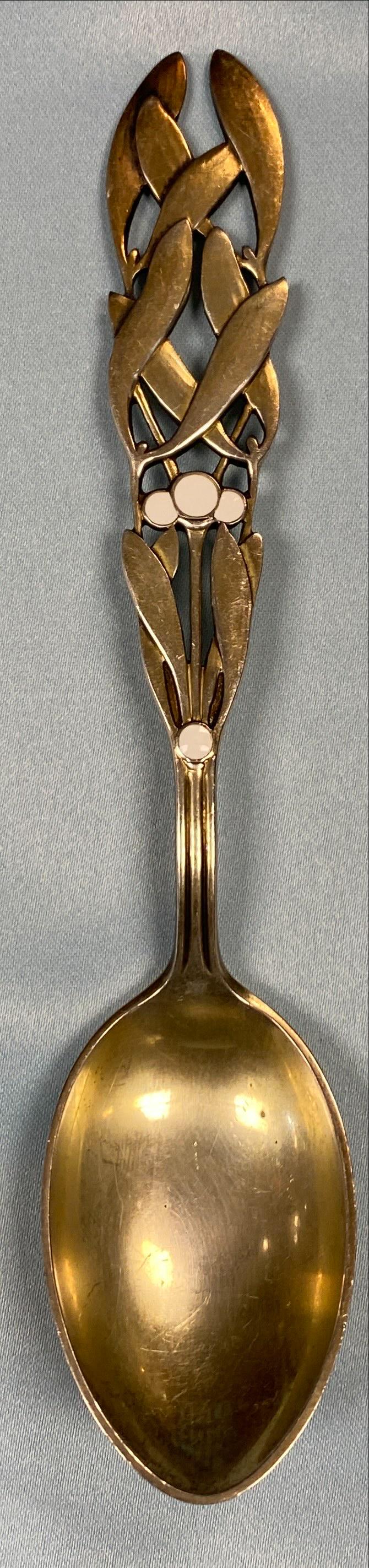 1941 Christmas Themed Spoon Sterling Silver: Danish sterling silver gilt Christmas spoon for 1941, Mistletoe, in white enamel by A. Michelsen of Copenhagen, Denmark. Dimensions: Spoon Length 6.25" Spoon Metal Sterling
