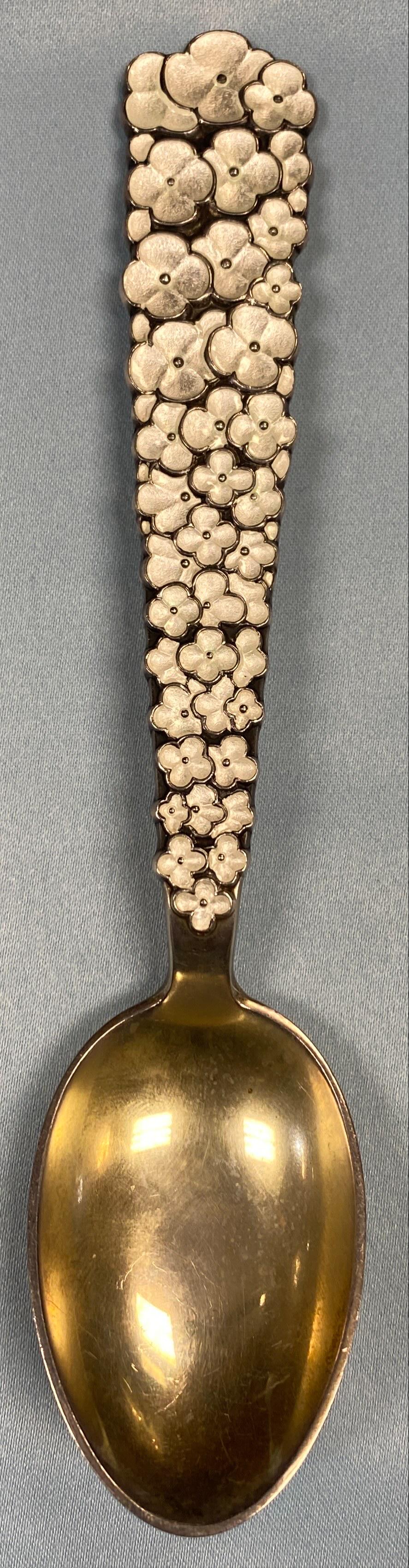 1956 Christmas Themed Spoon Sterling Silver: Danish sterling silver gilt Christmas spoon for 1956, Snow Flowers in white guilloche enamel by A. Michelsen of Copenhagen, Denmark. Dimensions: Spoon Length 6.25" Spoon Met