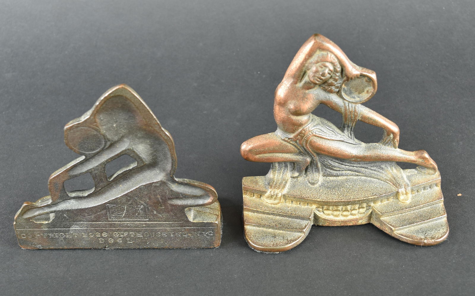 Pair of Nude Tambourine Dancer Bookends 1926 Art Deco: This pair of Art Deco bookends feature Nude Tambourine Dancers. They were made by Gift House, NYC in 1926. They appear to have the original felt on the bottoms. They are both stamped with the BronzMet